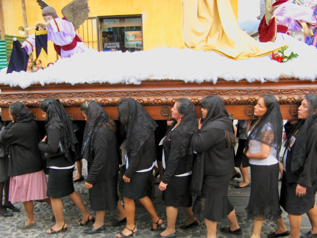 Women wearing heels carry the Virgin Mary float through Antigua's bumpy, cobblestone streets. ©Laurel Kallenbach