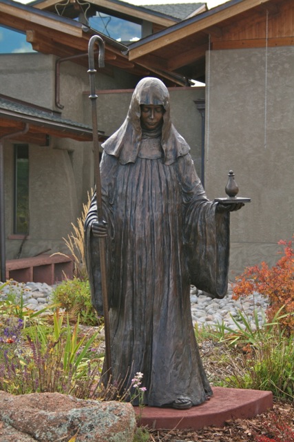 Carrying a bottle of healing oil, St. Walburga welcomes visitors to the Abbey. ©Laurel Kallenbach