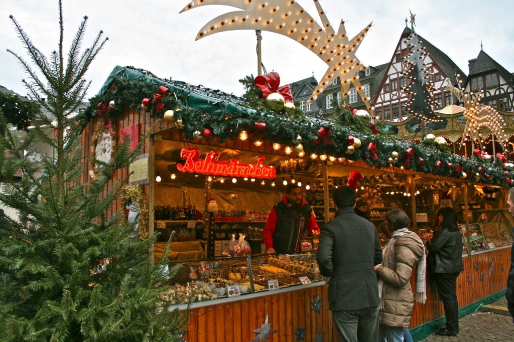 With its backdrop of half-timbered houses, historic Römer Square is in the Old World heart of the Christmas Market in Frankfurt, Germany. This hut sells Bethmännchen marzipan cookies, a local specialty. ©Laurel Kallenbach