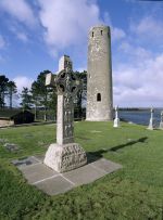 A high cross and round tower at Clonmacnoise.