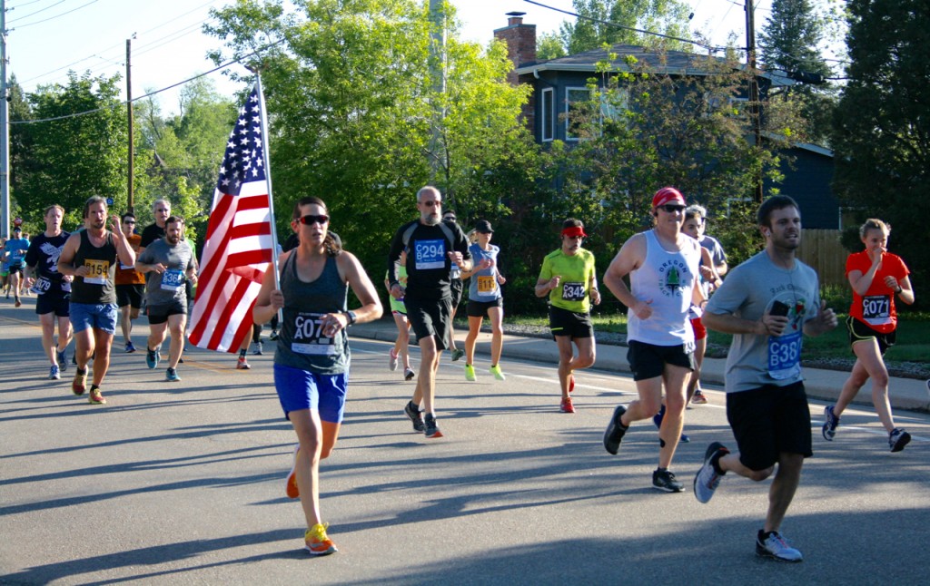 This woman carried the flag throughout the Bolder Boulder race. ©Laurel Kallenbach