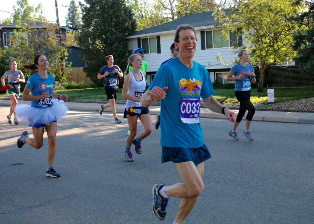 My husband's smile as he zooms by says it all: the Bolder Boulder is fun!©Laurel Kallenbach